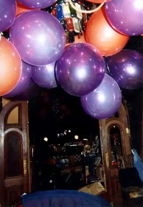 Purple and orange balloons hanging in a doorway of the Third Street loft.